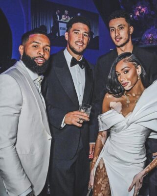 Unveiling the Glamour: Devin Booker Steals the Spotlight at the 2023 amfAR Gala Canes Show, Joined by OBJ, Kyle Kuzma, Winnie Harlow, and Zach Bia